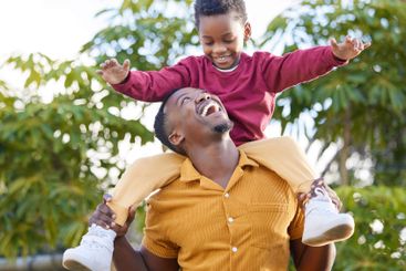 Papa, smile and black man piggyback son, fun and joy...