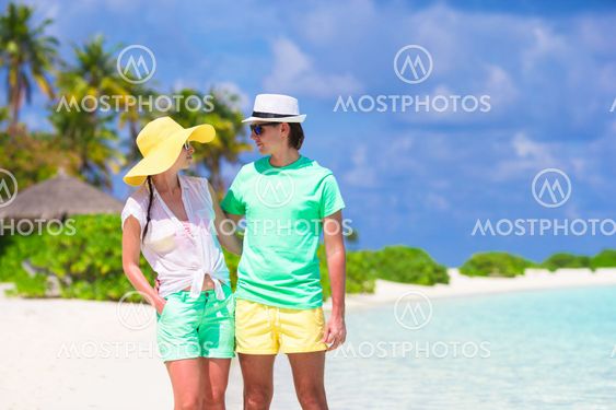 Young happy family on white beach at summer vacation