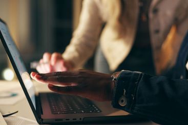 Laptop, screen and business people together at night for...