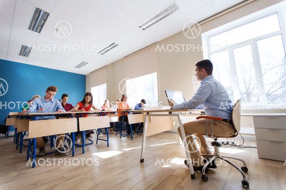students and teacher with tablet pc at school