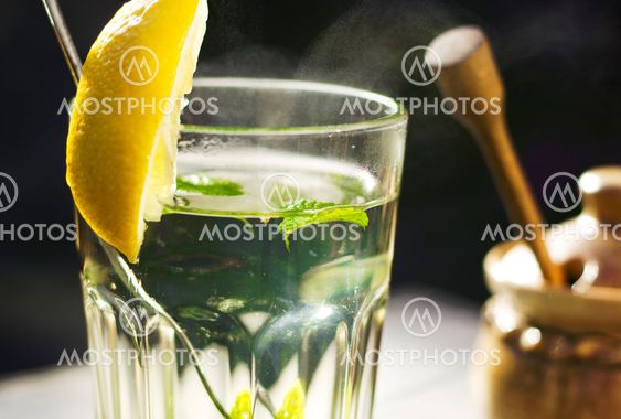Close up of a glass of tea with a fresh peppermint