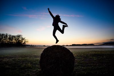 Happy woman jumping for joy on the background of the...