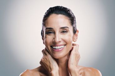 Beauty, portrait and smile of woman in studio for...