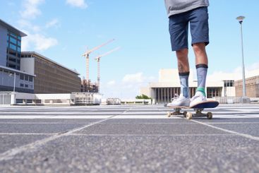 Person, legs and city with skateboard for ride, extreme...