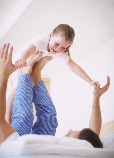 Father, girl and flying games in home, morning fun and...