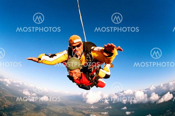 Smiling skydivers mid air