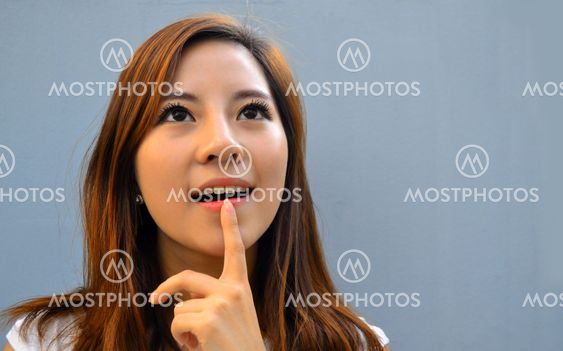 Beautiful young asian woman thinking