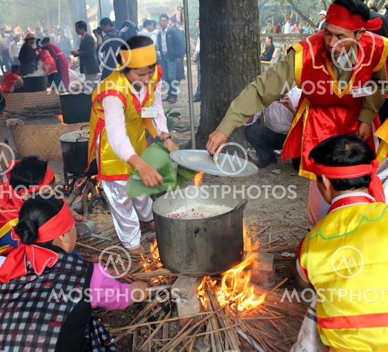 People in traditional costume exam to make square...