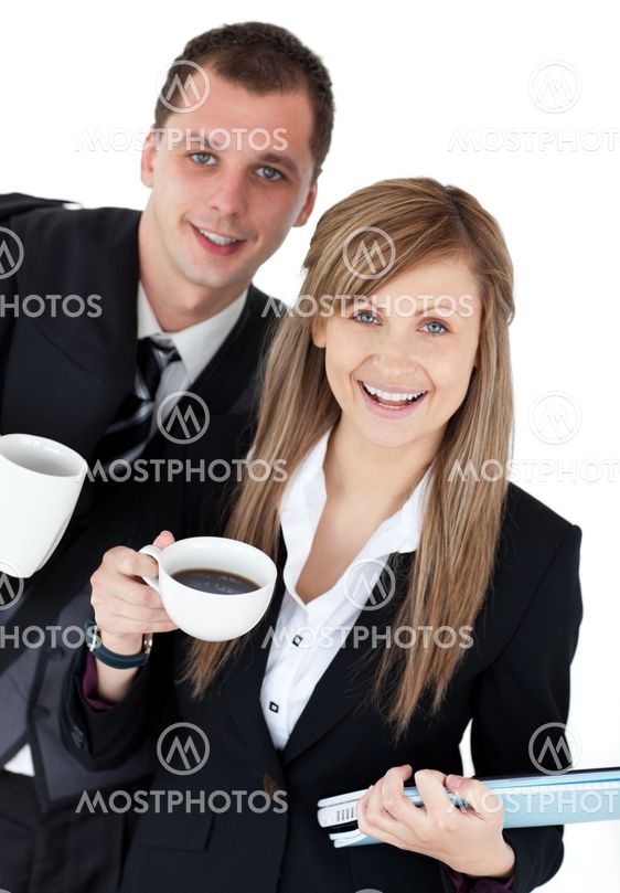 Happy couple of business holding a coup smiling at the camera