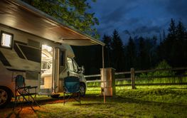 Cozy Camping Experience With a Camper Van Under a Night Sky