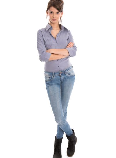 Isolated young woman in blue jeans and full body length.