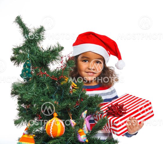 Little girl in Santa's hat with gift box