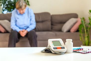 An old woman measures her blood pressure. Selective focus.