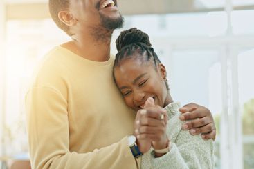 Black couple, dance and hug in home together with love,...