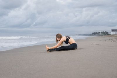attractive young woman practicing yoga in Caterpillar...