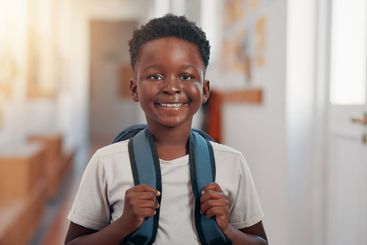 Smile, backpack and portrait of black child in school...
