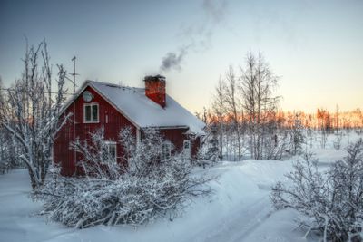 Smoke from the chimney of a Swedish house in winter