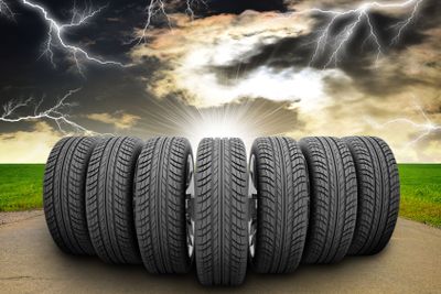 Wedge of car wheels. Road, roadsides, grass field and...