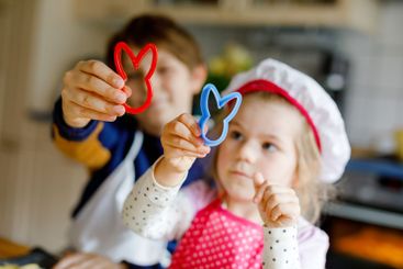 Cute little toddler girl and preteen kid boy baking...