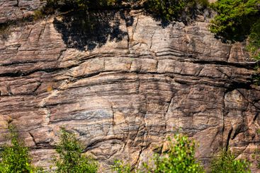 Compressed rock layers on a cliff face.