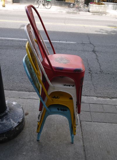 Stacked multicoloured metal chairs