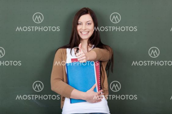 Woman Holding Files While Showing Thumbsup Sign Against...