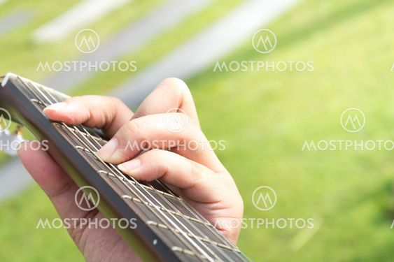 hand playing on guitar