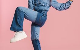 Excited black woman gesturing and using mobile phone