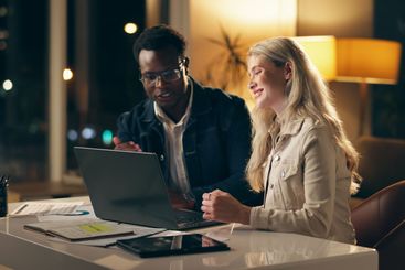 Laptop, discussion and business people together at night...