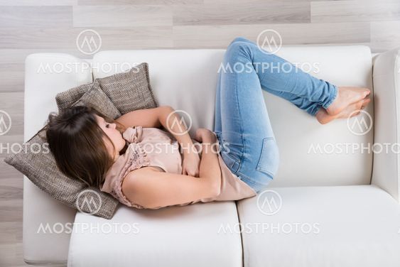 Young Woman Napping On Sofa