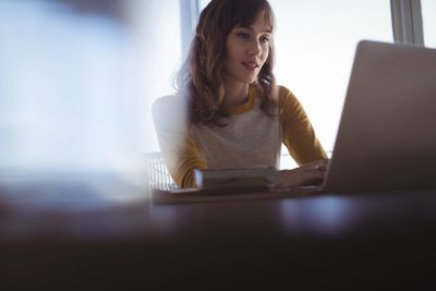 Concentrated businesswoman working at office