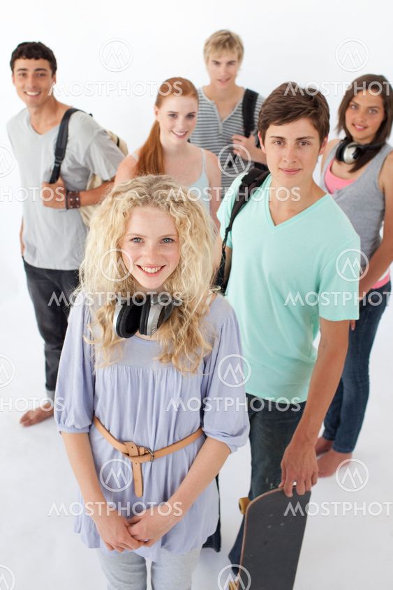 Happy teenagers smiling at the camera with bags