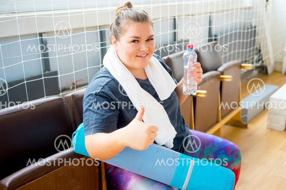 Overweight girl in a gym