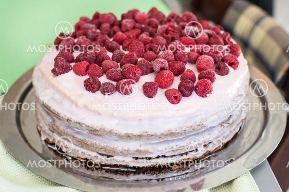 Fresh dessert fruit tart covered in raspberries