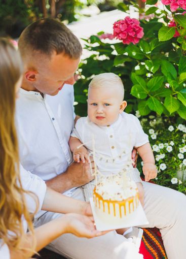 Mom and dad in nature with their one-year-old son...