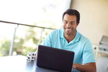 Home, man and excited with laptop in balcony, remote...