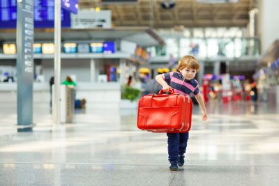 little tired kid boy at the airport, traveling