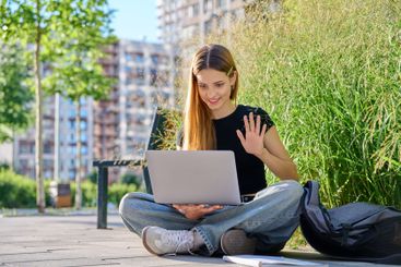 Teen female student using laptop for video chat