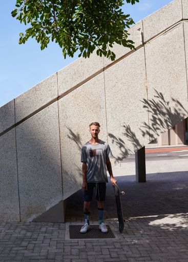 Skateboard, portrait and urban with man in city for...