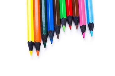 Vibrant colored pencils arranged in a line ready for...
