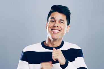 Celebration, dancing and man with smile, studio and...