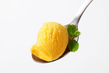 Yellow ice cream on spoon