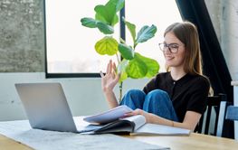 Young woman university student studying using laptop...