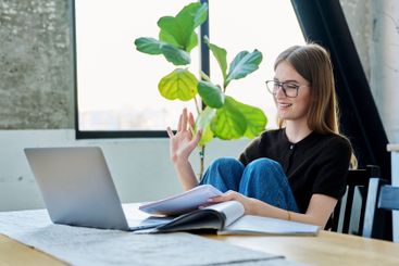 Young woman university student studying using laptop...