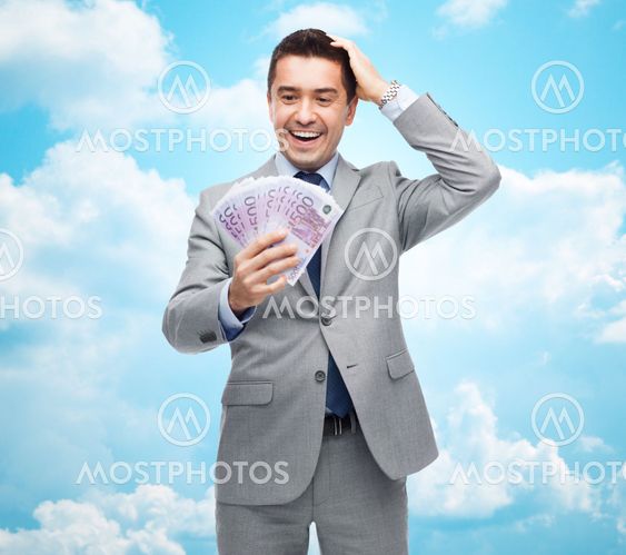happy laughing businessman with euro money