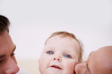 Kiss, baby and happy parents in home for child...