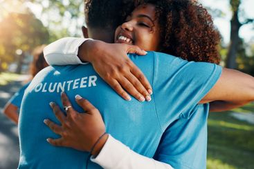Volunteer, smile and hug with people in park for recycle...