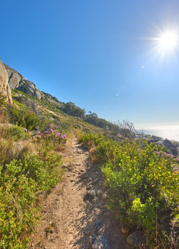 Hill, pathway and trail with blue sky in environment for...