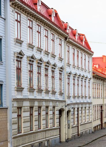 historic european street with red roofed buildings.