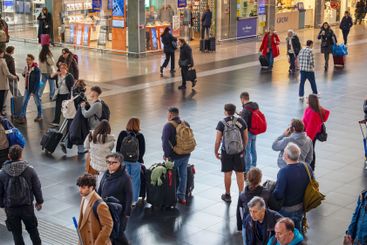 Travelers inside the Roma Termini railway station, in...